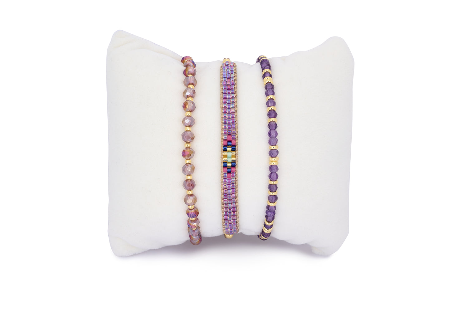 Komodo Amethyst & Gold Bracelet Stack featuring three handcrafted purple and pink beaded bracelets with gold accents, symbolising calm and confidence.