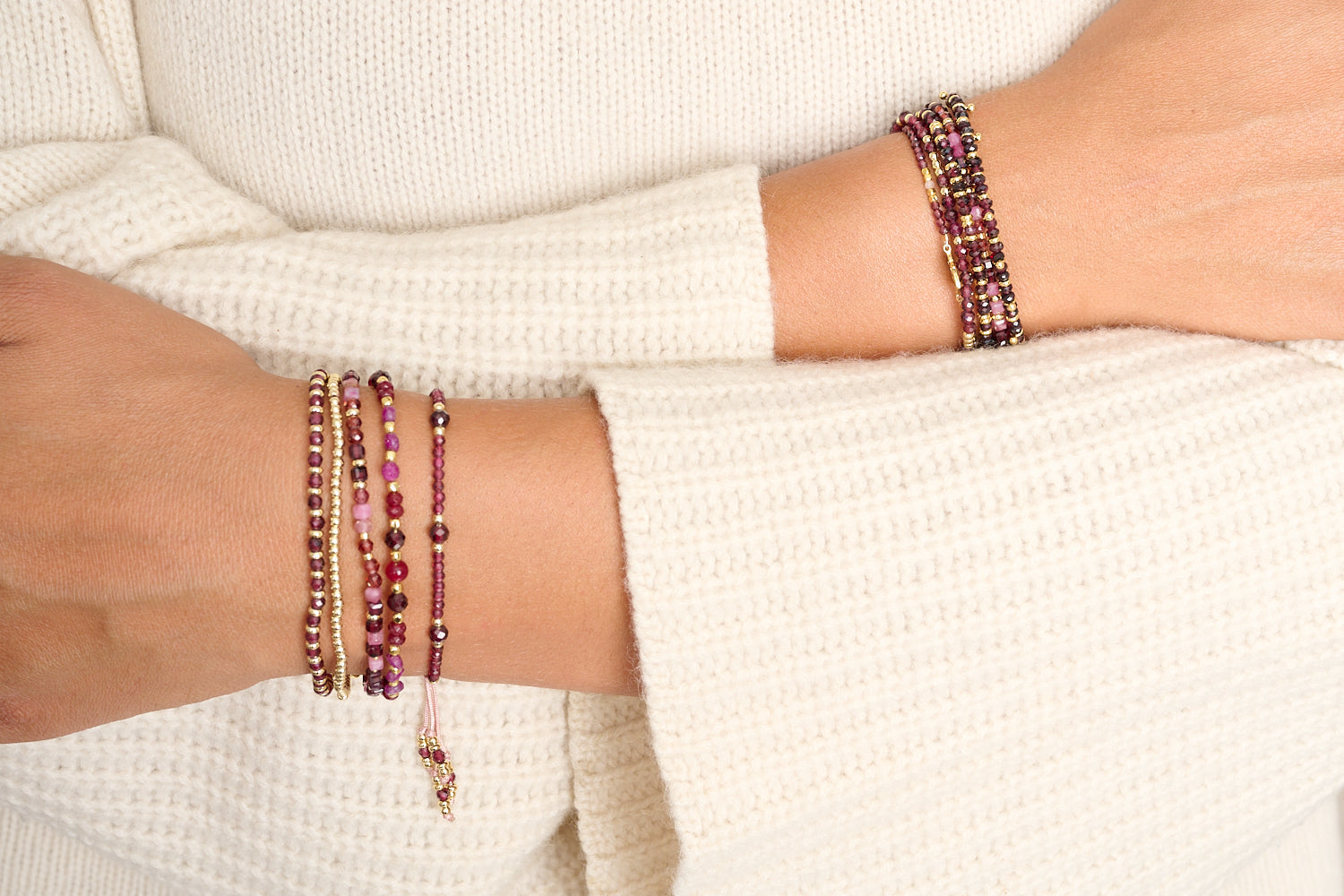 Laria garnet January birthstone bracelet featured on wrist with Boho Betty stacking bracelets