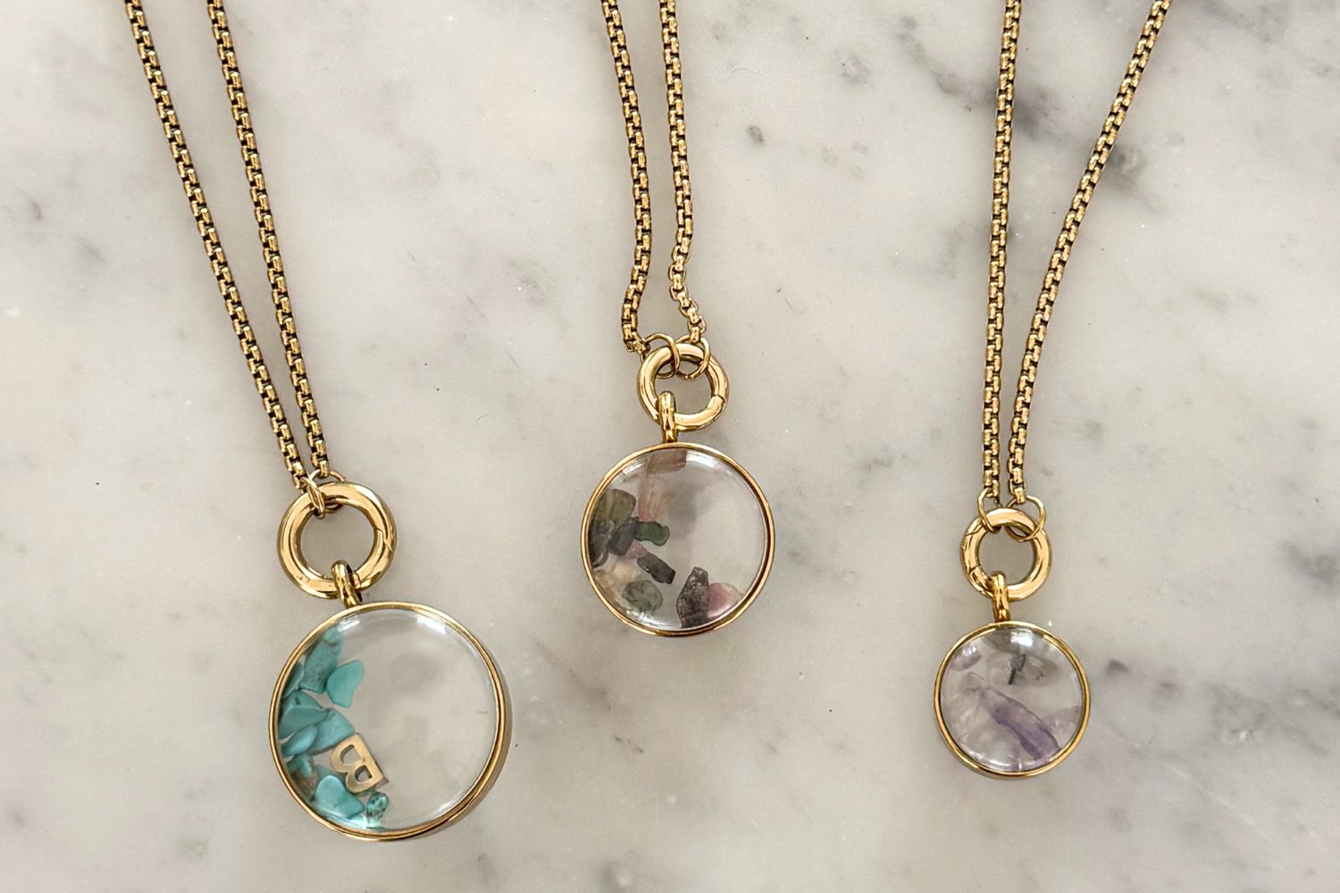 Leilani midi gold locket necklace styled on the neckline, a personalised charm locket perfect for layering and everyday wear.