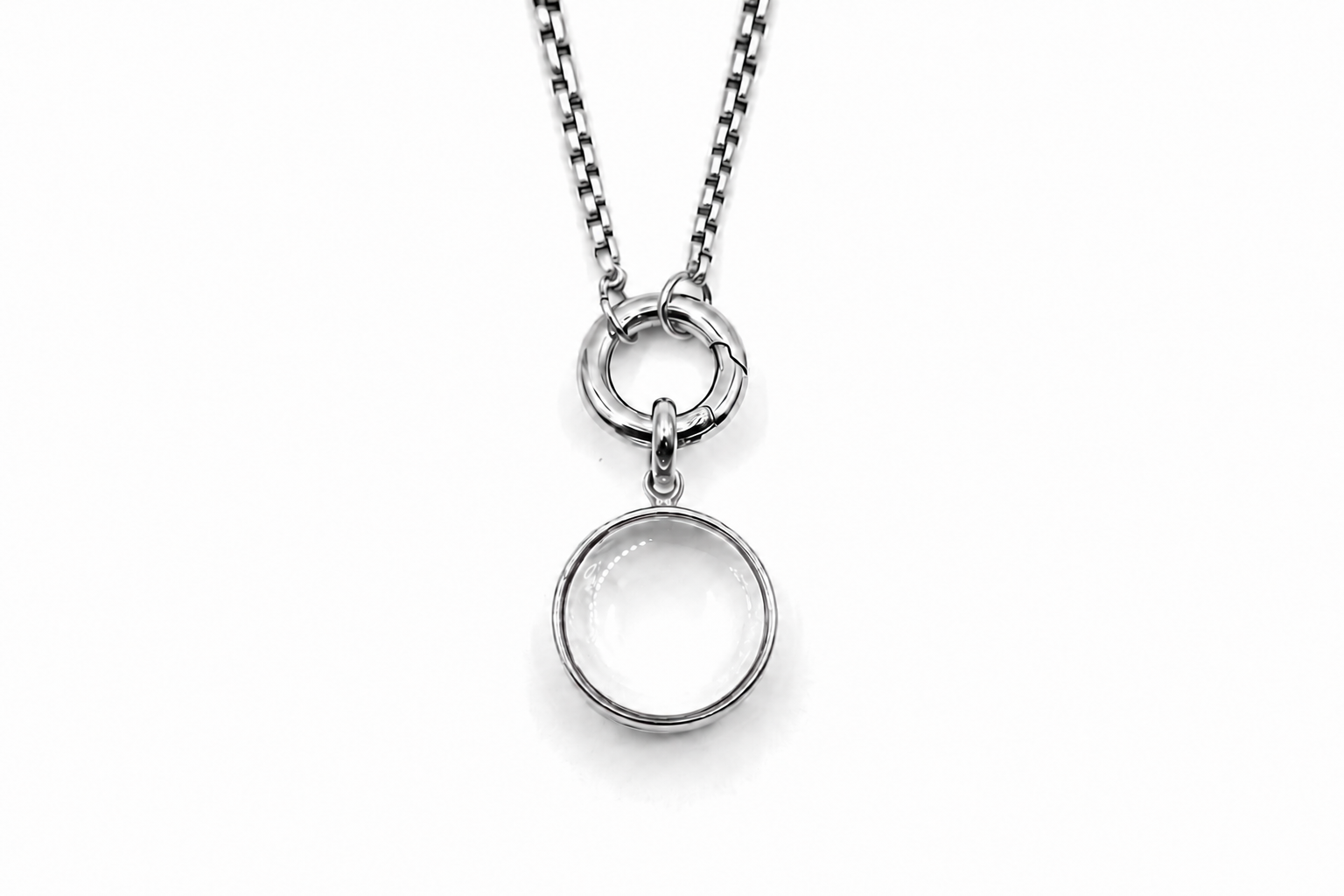 Leilani mini silver locket necklace with glass front designed to hold gemstone chips and letter charms on a polished silver chain.