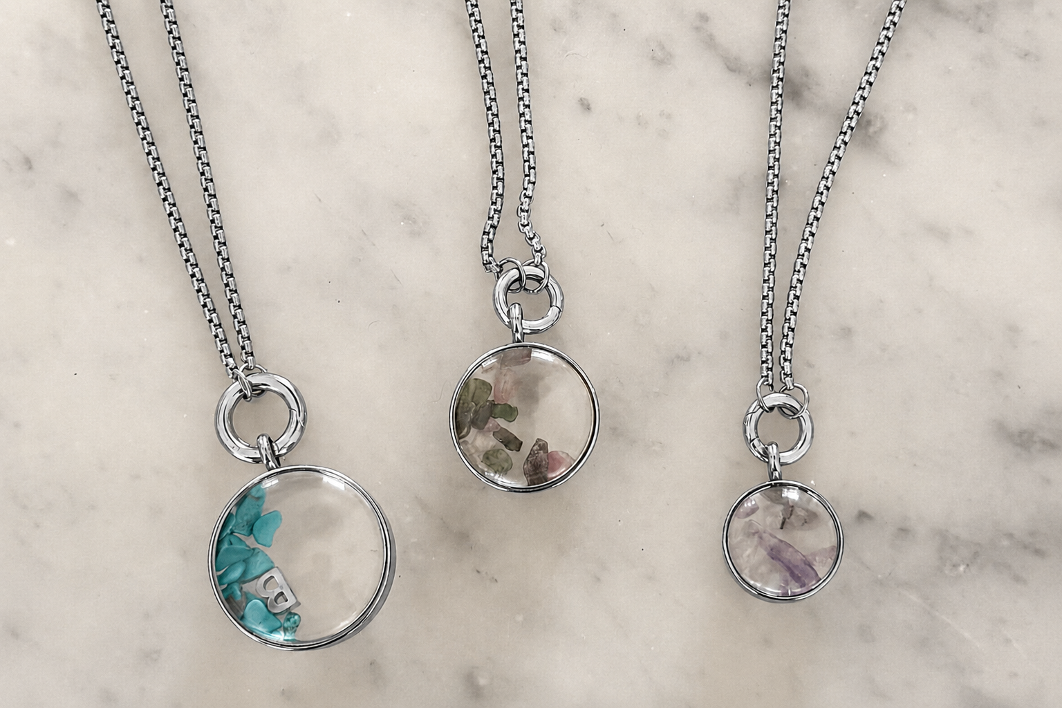 Leilani mini silver locket necklace styled on the neckline, a personalised charm locket perfect for layering and everyday wear.