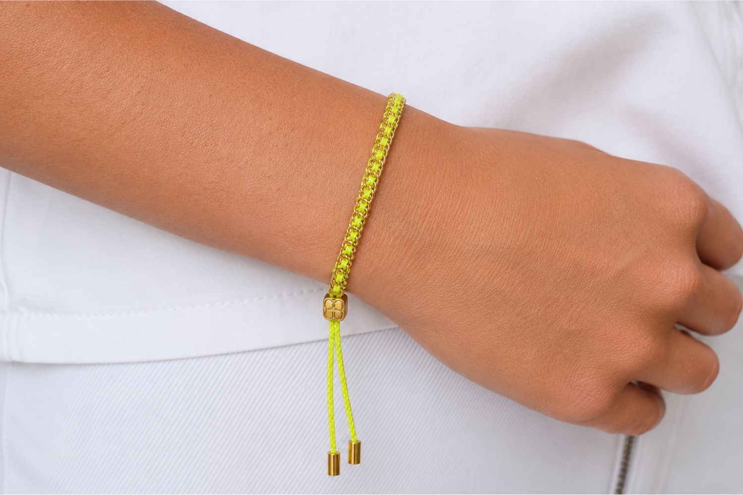 Lilia Gold & Neon Yellow Woven Bracelet styled on the wrist with neon yellow woven detailing and warm gold accents for bold boho stacking.