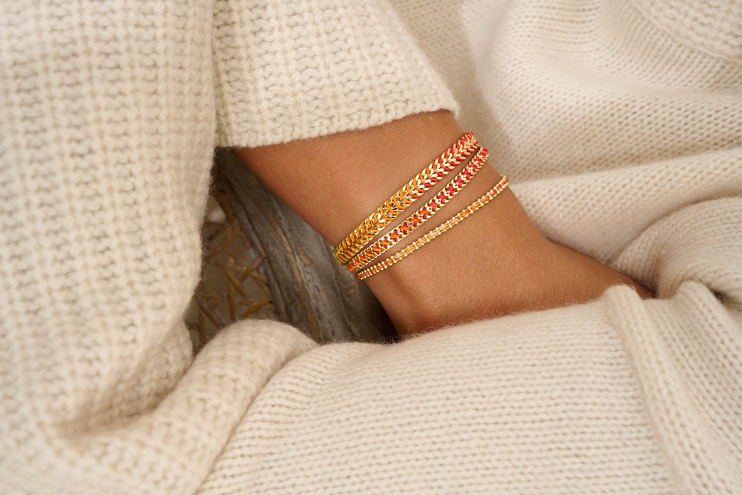 Lilia Golden Sunset Ombre Braided Bracelet styled on wrist, showcasing vibrant sunset shades and shimmering gold chain for the perfect summer jewellery look.