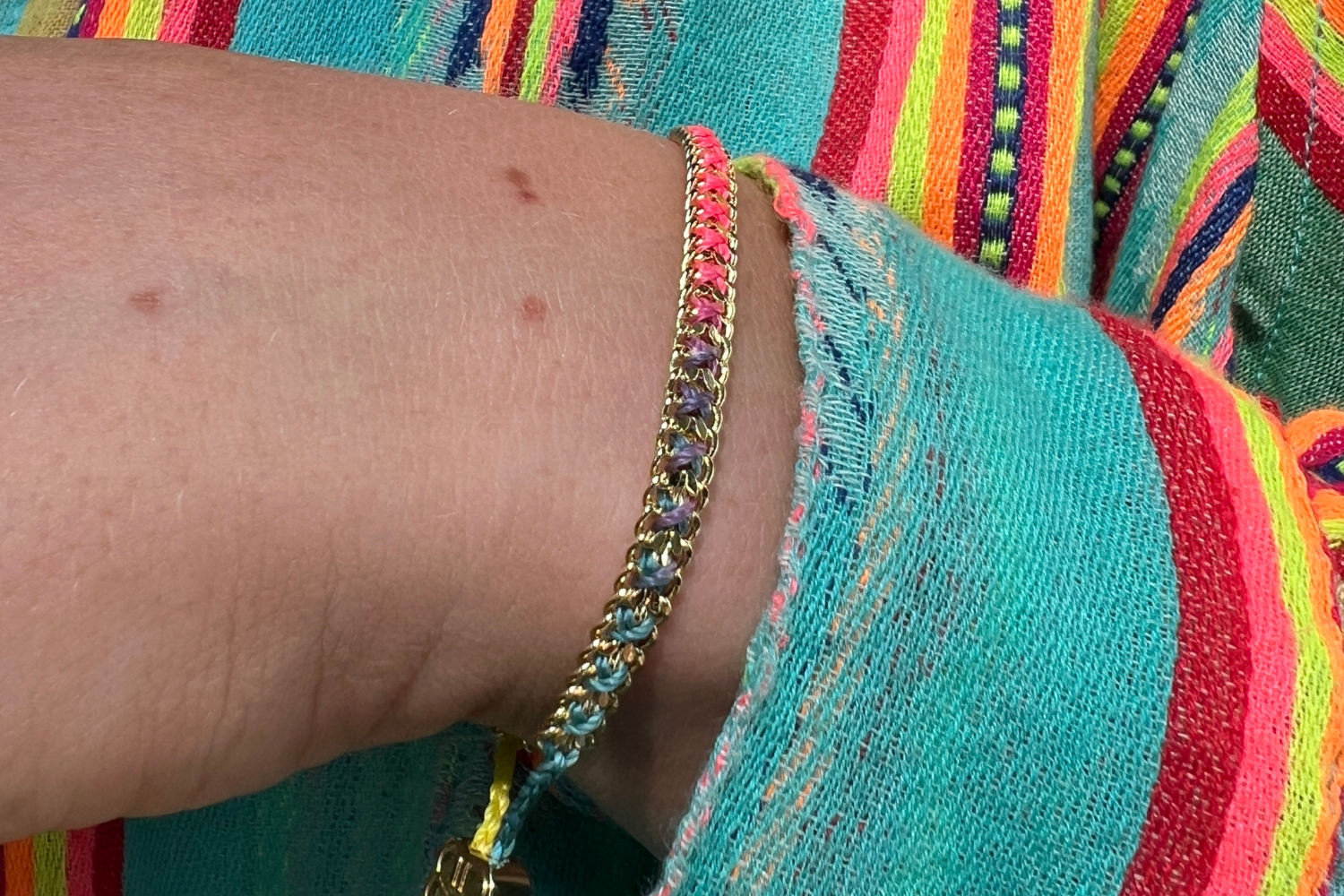 Lilia Havana Brights Gold Braided Bracelet styled on the wrist, showcasing colourful woven threads and warm 14k Gold PVD details for effortless boho layering.