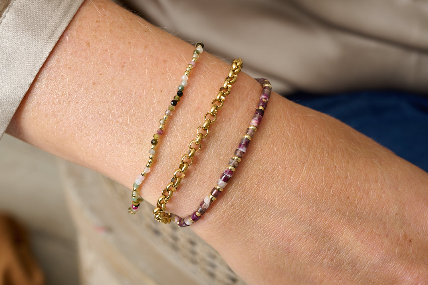Lilias Tourmaline Gemstone Bracelet styled with layered beaded bracelets in warm gold and earthy tones for a calming, boho-inspired look.