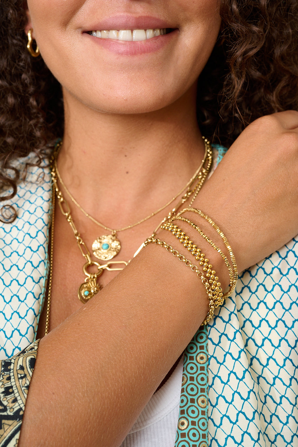 Marisol Gold Beaded Friendship Bracelet styled on the wrist, showcasing layered gold beads and neutral cord in a beach-inspired boho look.