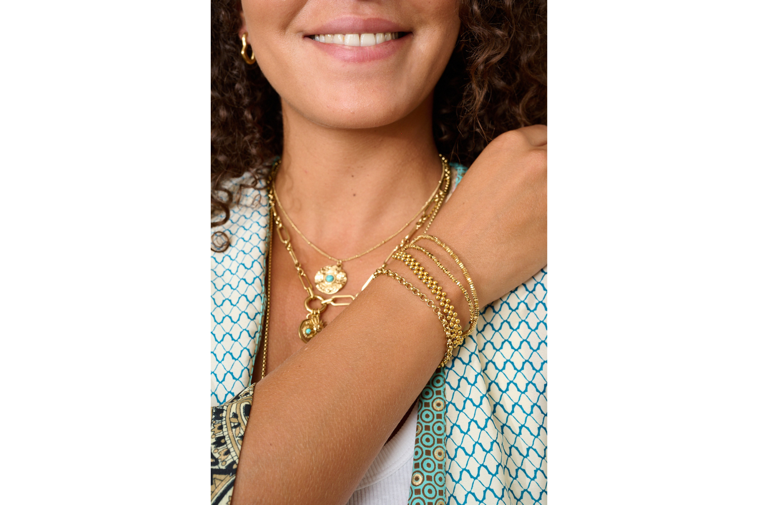 Marisol Gold Beaded Friendship Bracelet styled on the wrist, showcasing layered gold beads and neutral cord in a beach-inspired boho look.