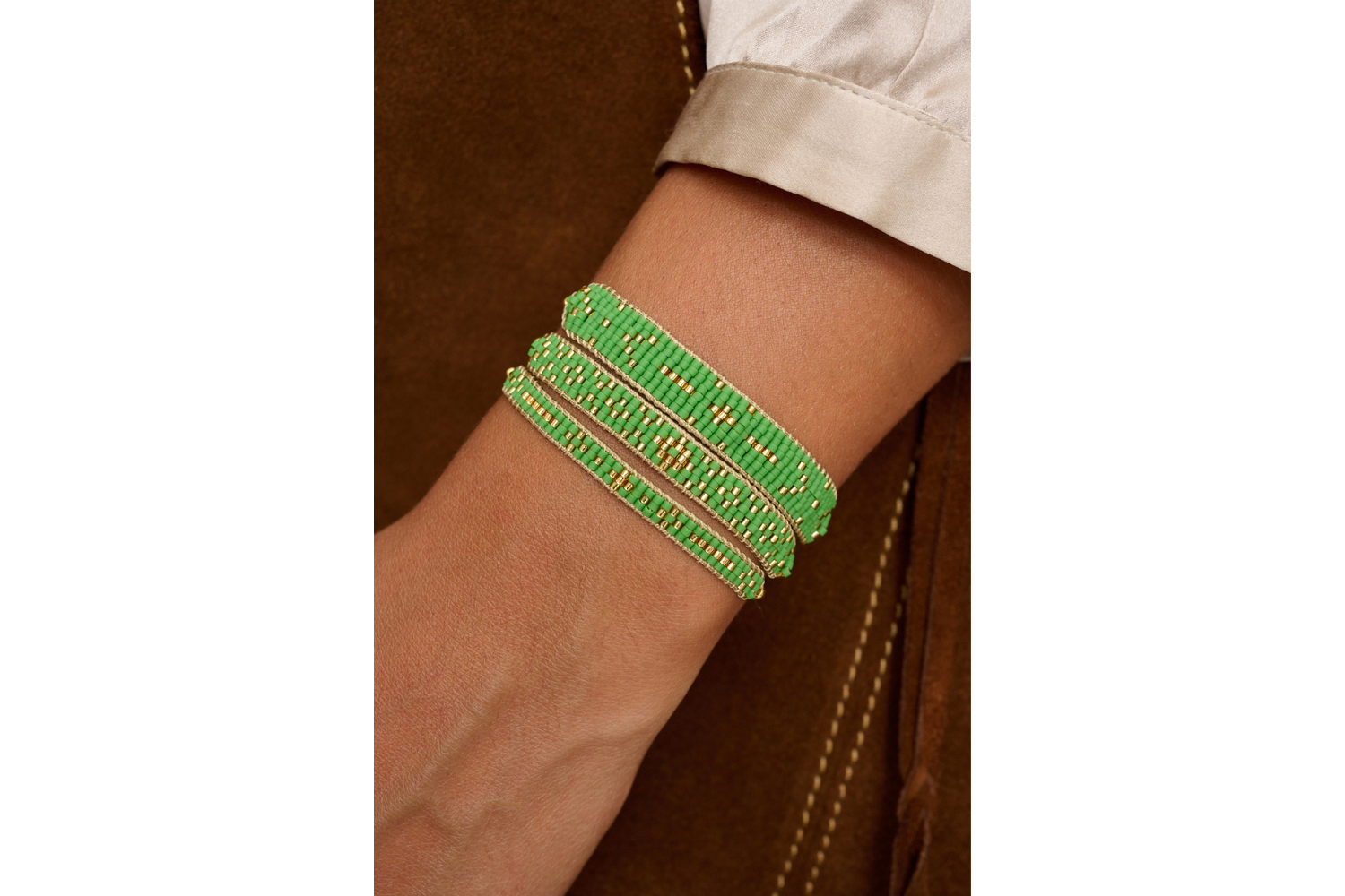 Maya green and gold bracelet featured on wrist with Boho Betty stacking bracelets