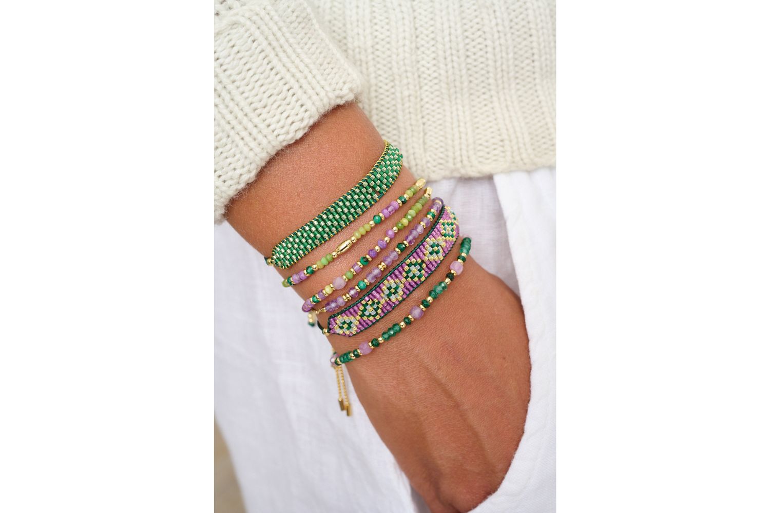 Meli gold, green and purple stretch bead bracelet featured in colourful Boho Betty bracelet stack on wrist