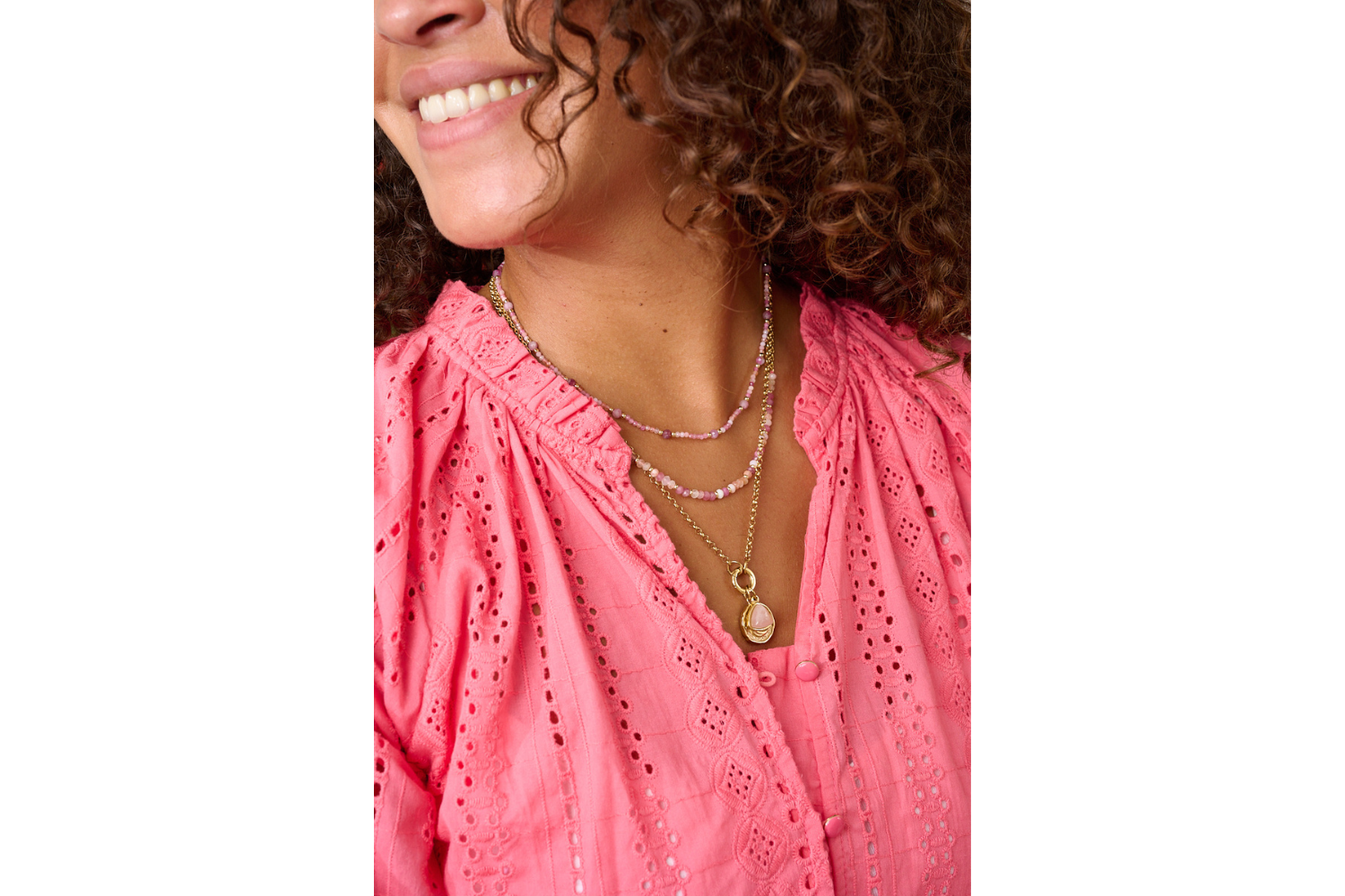 Boho chic necklace stack featuring the Melrose Pink Tourmaline Mix Gold Necklace with multiple gold and gemstone pieces, styled for a warm, feminine look.