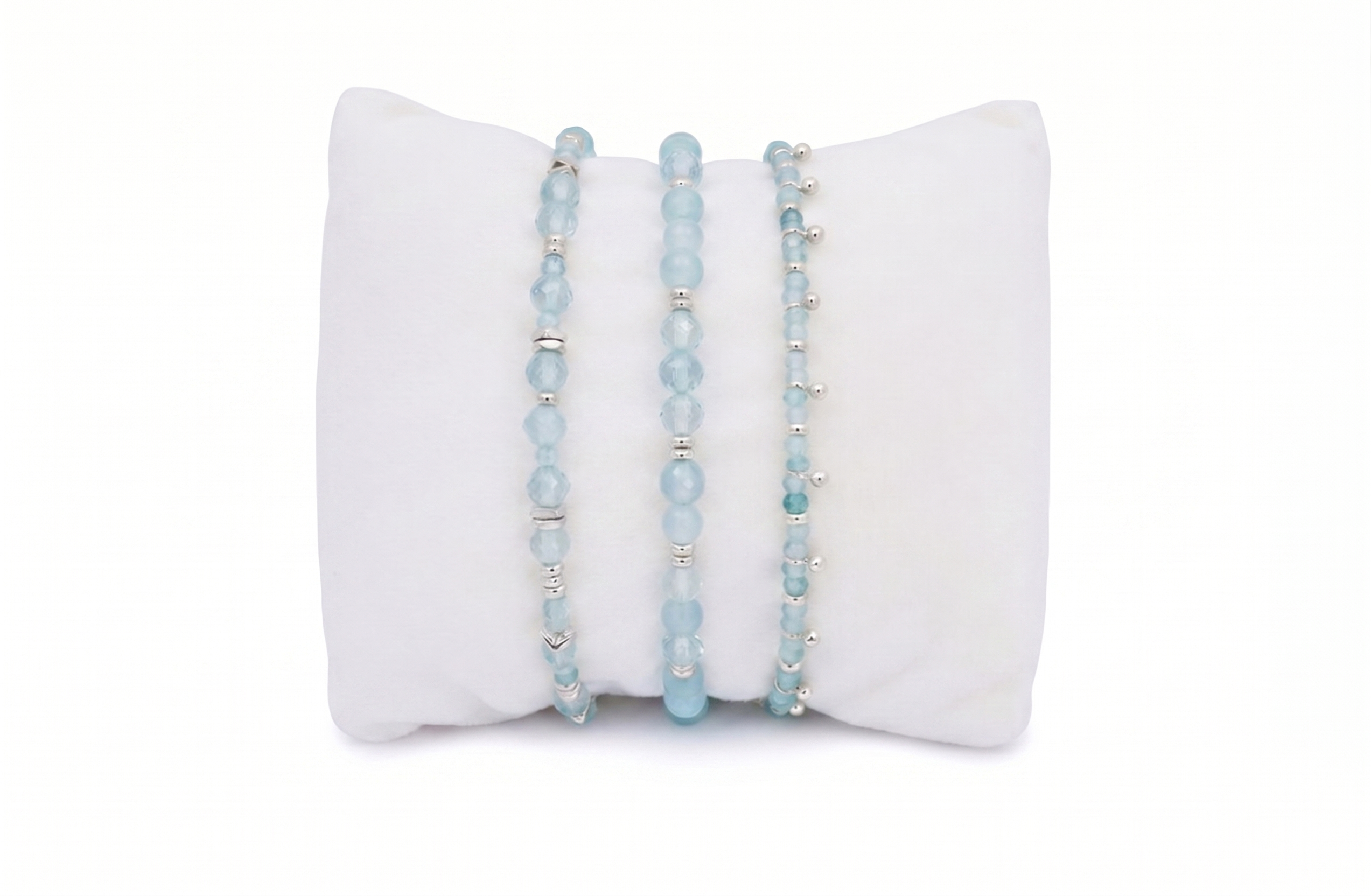 Moala blue topaz silver bracelet stack, shimmering blue gemstone bracelets with polished silver accents and adjustable slider fits