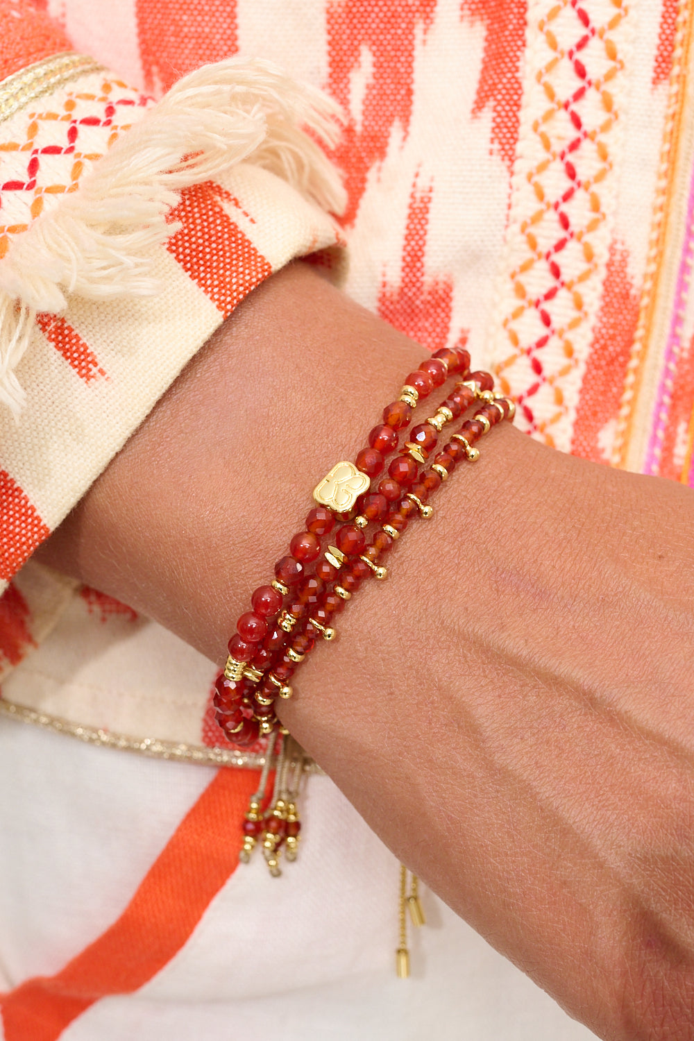 Moala Red & Orange Agate Gold Bracelet Stack styled on the wrist, showcasing vibrant gemstones and golden details for a radiant, summer-ready look.