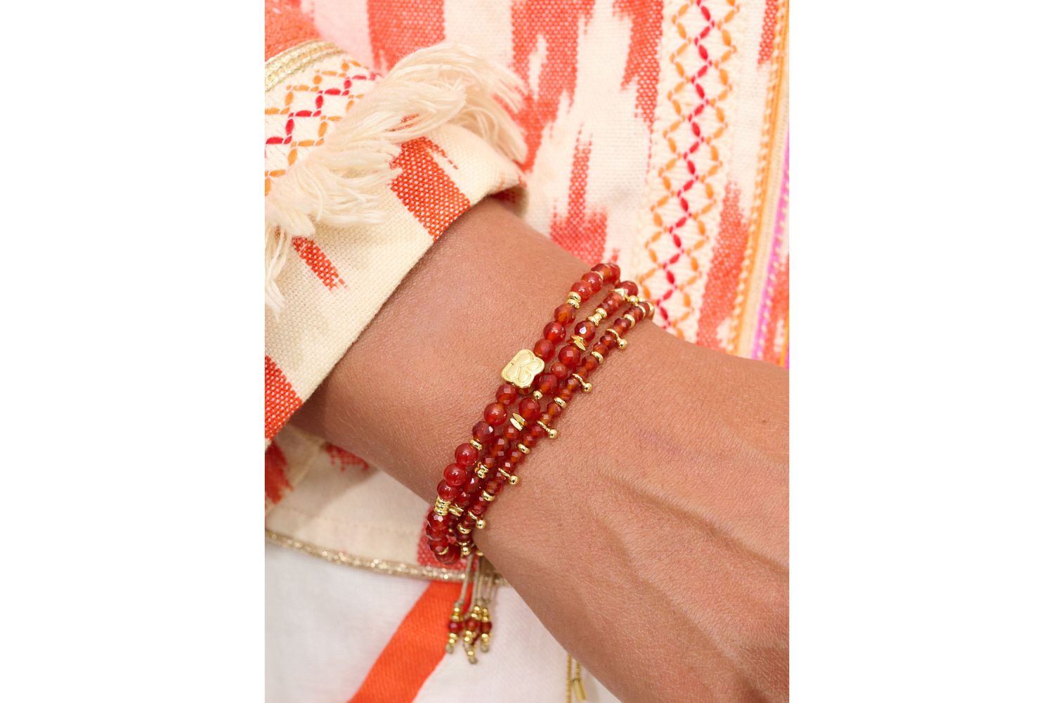 Moala Red & Orange Agate Gold Bracelet Stack styled on the wrist, showcasing vibrant gemstones and golden details for a radiant, summer-ready look.