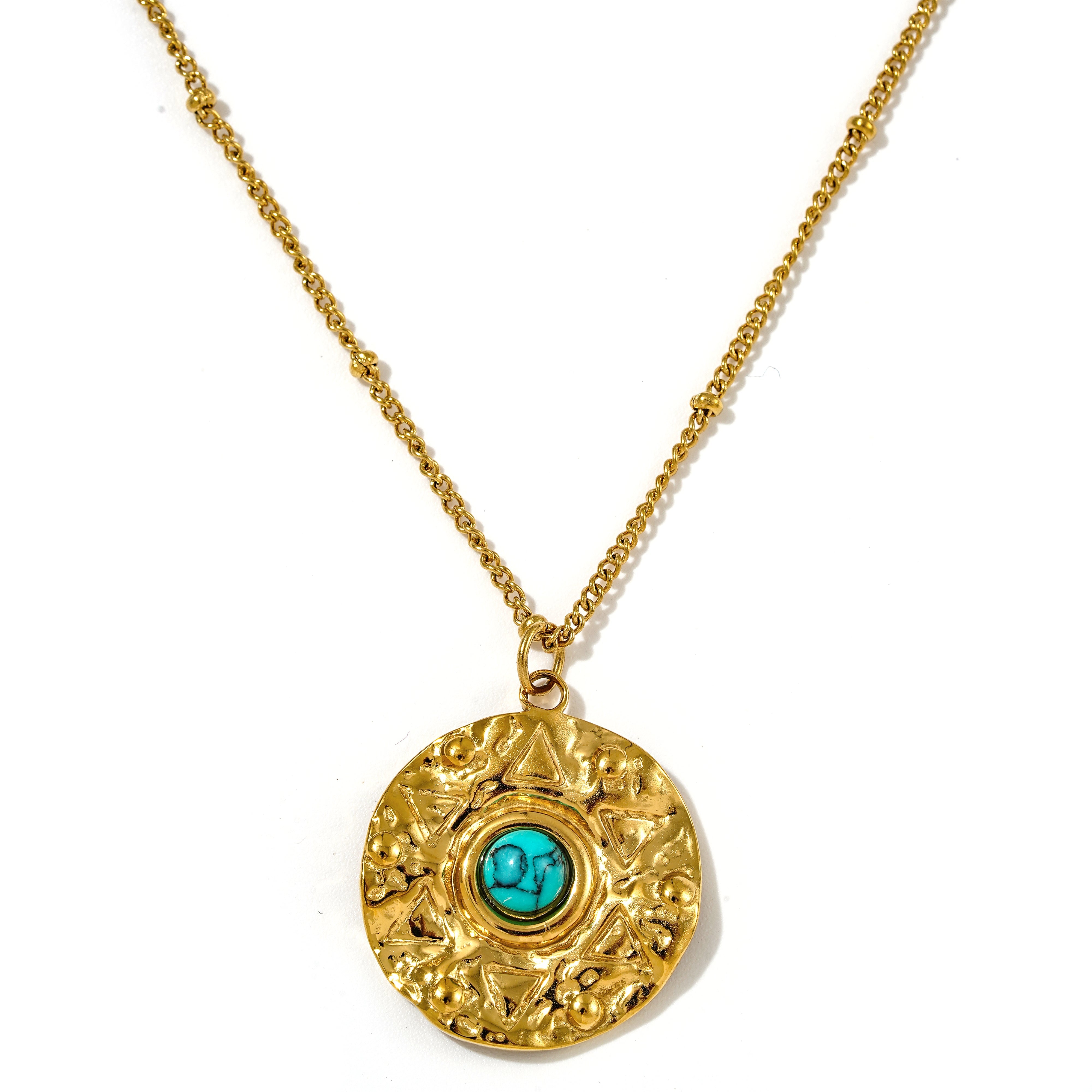Nerissa Turquoise Howlite Gold Amulet Necklace with textured disc pendant on a beaded gold satellite chain.