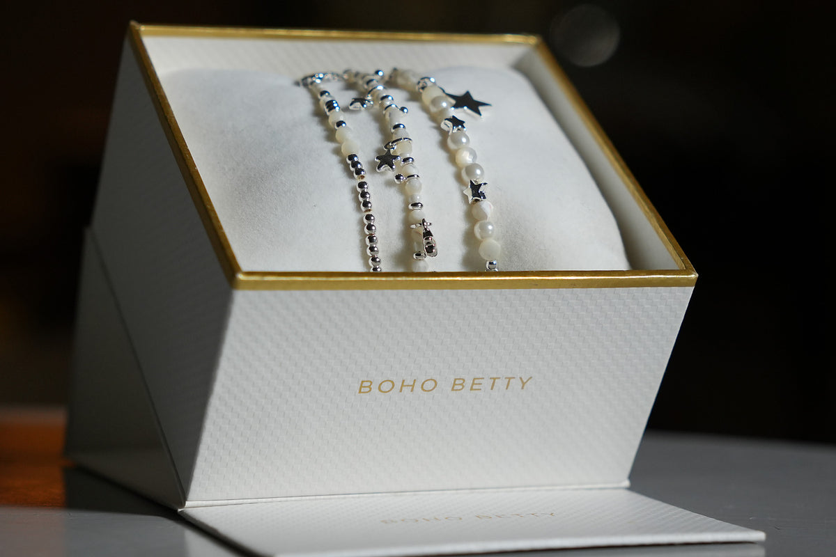 Orion White Pearl & Silver Star Bracelet Stack presented in a white and gold Boho Betty gift box, ready to give