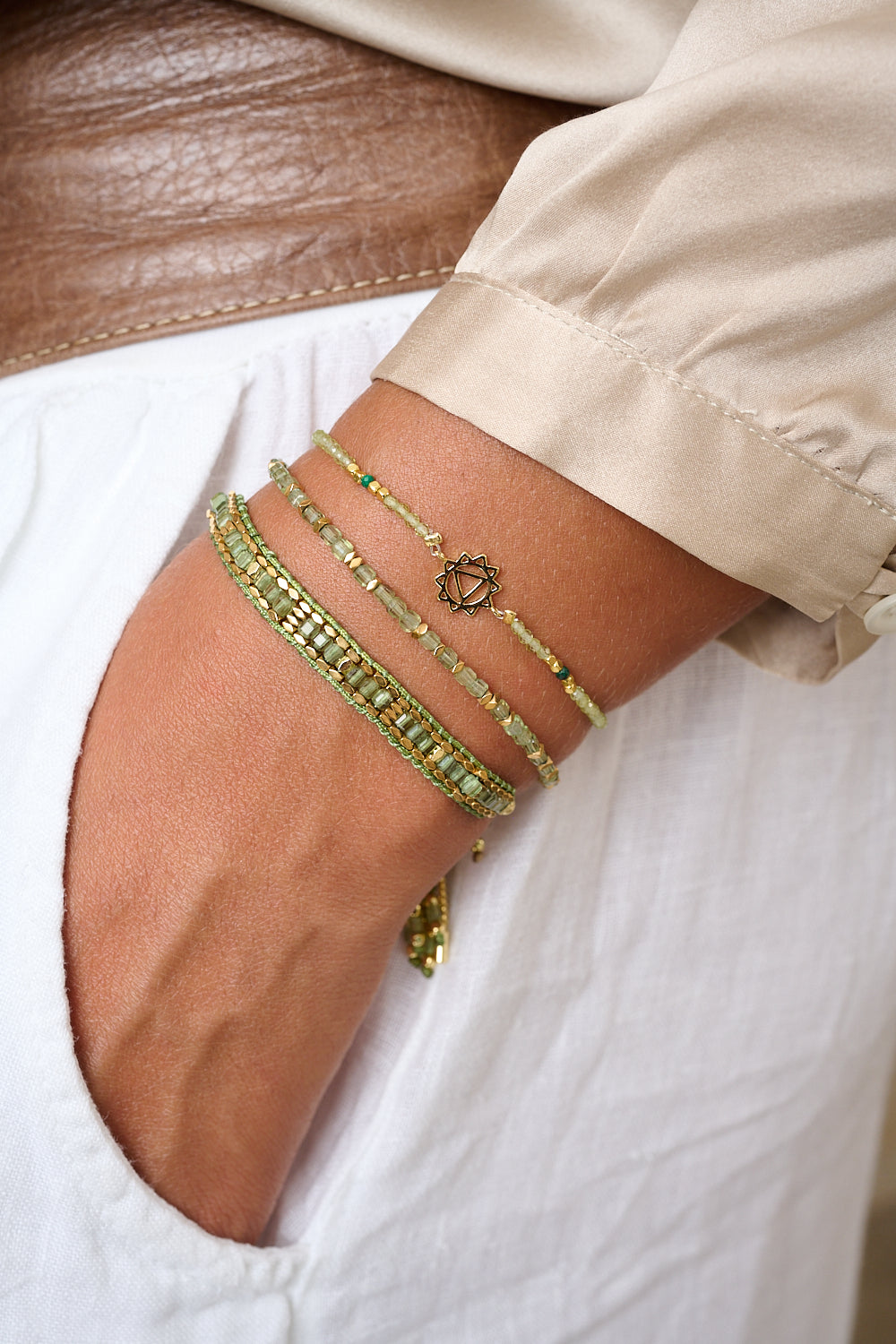 Peridot & Malachite Gold Solar Plexus Chakra Bracelet styled on wrist, showcasing the symbolic Solar Plexus Chakra charm and vibrant gemstone beads
