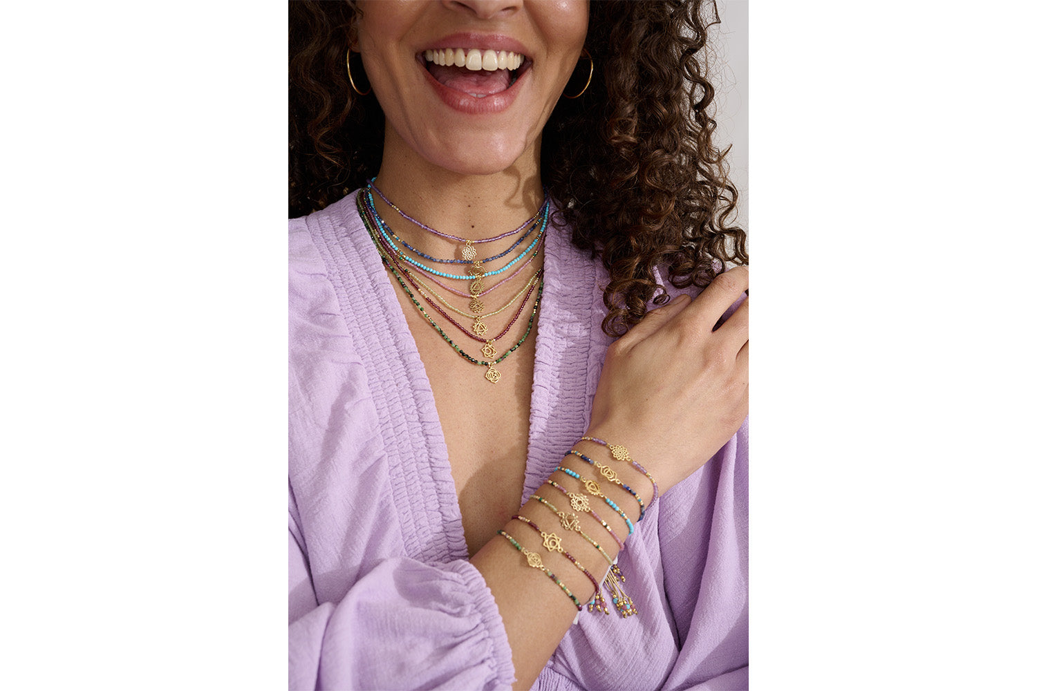 Pink Tourmaline & Malachite Gold Heart Chakra Necklace styled on the neckline, showcasing delicate gemstones and shimmering gold accents.