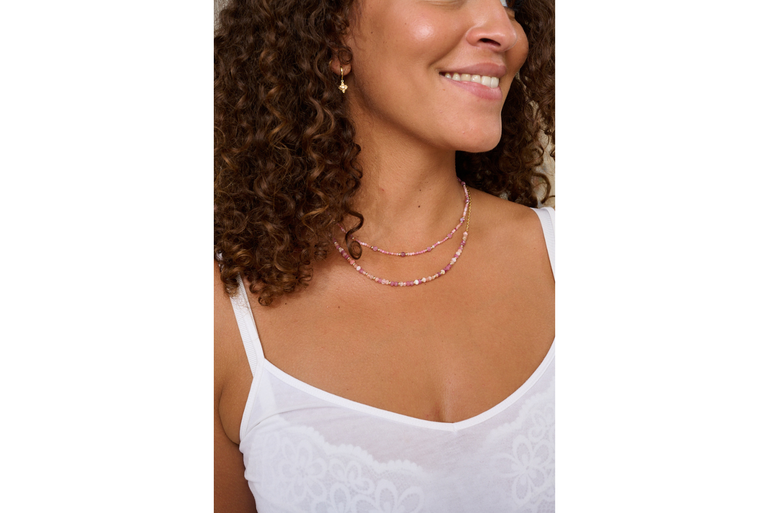 Posey Pink Tourmaline Necklace styled with layered gold jewellery and soft fabrics, creating a romantic, sunlit look.