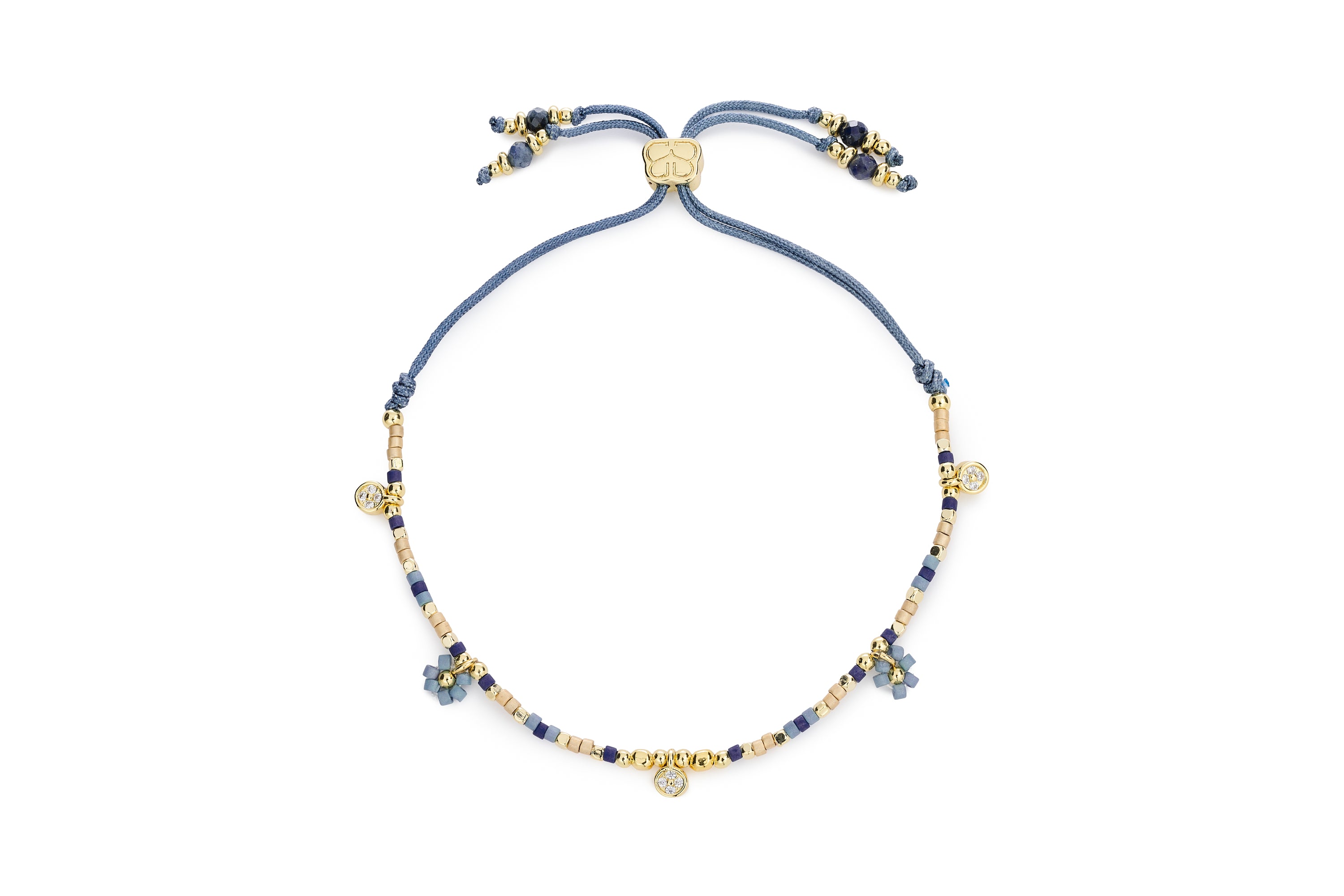 Rania Denim & Gold Beaded Charm Bracelet featuring matte navy beads, gold-tone floral and crystal charms, and an adjustable cord slider.