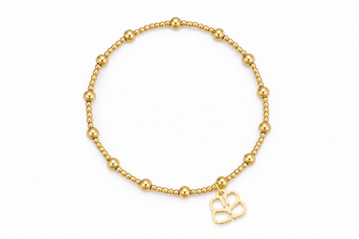 Rosa waterproof gold bead stretch bracelet by Boho Betty – fine and larger gold beads with logo charm, 18cm stretch fit, stackable and waterproof
