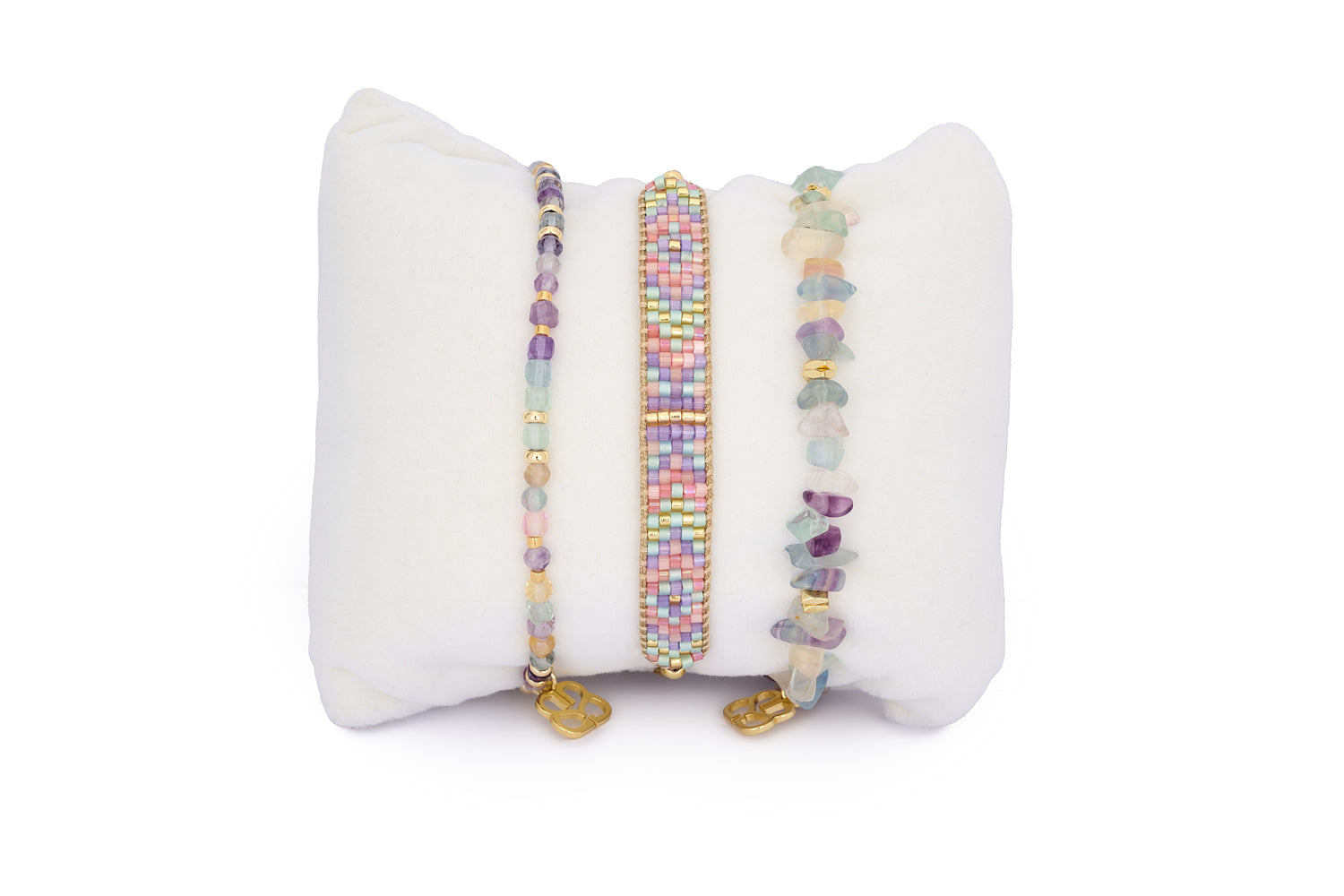 Saba Rainbow Fluorite & Gold Bracelet Stack featuring three pastel-toned bracelets—rainbow fluorite crystal beads, a candy-coloured beaded bracelet, and a polished gemstone stretch style.