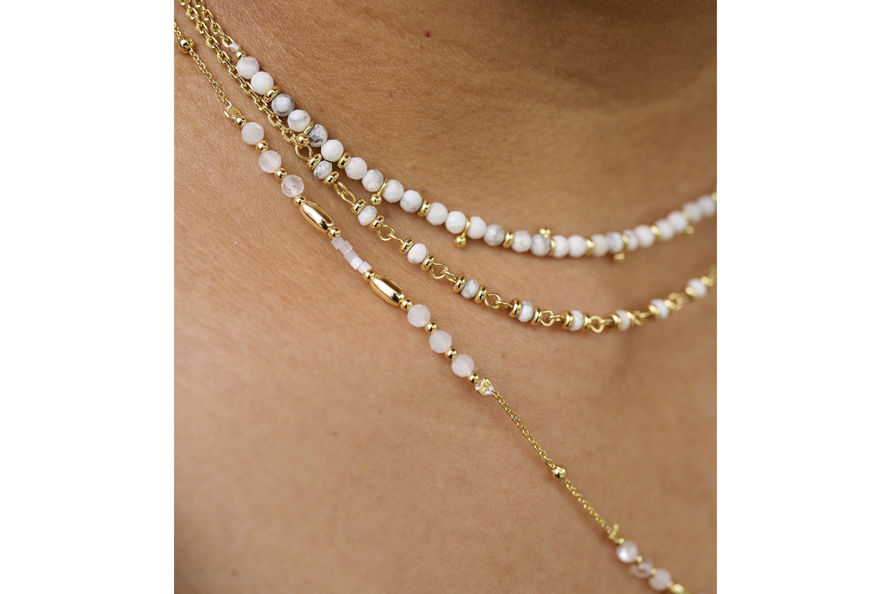 Salus White Howlite Gold Necklace styled with natural linens and boho layers for a serene, beach-ready look.