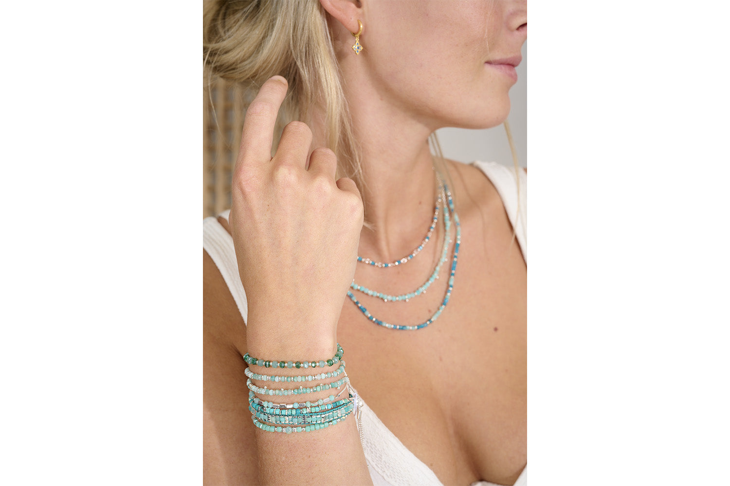 Seraphina Silver & Aqua Stretch Bead Bracelet styled on the wrist, showcasing ocean-inspired blue tones and silver accents—perfect for stacking or wearing solo.