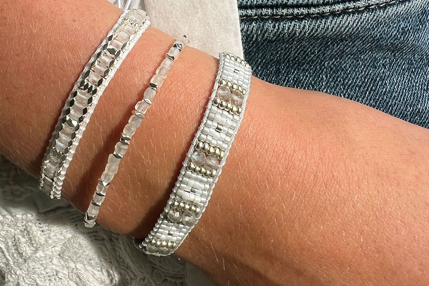 Seraphina White & Silver Stretch Bead Bracelet styled for boho-chic layering, highlighting soft white beads with silver accents—perfect for stacking, gifting, or wearing solo for a fresh, modern look.