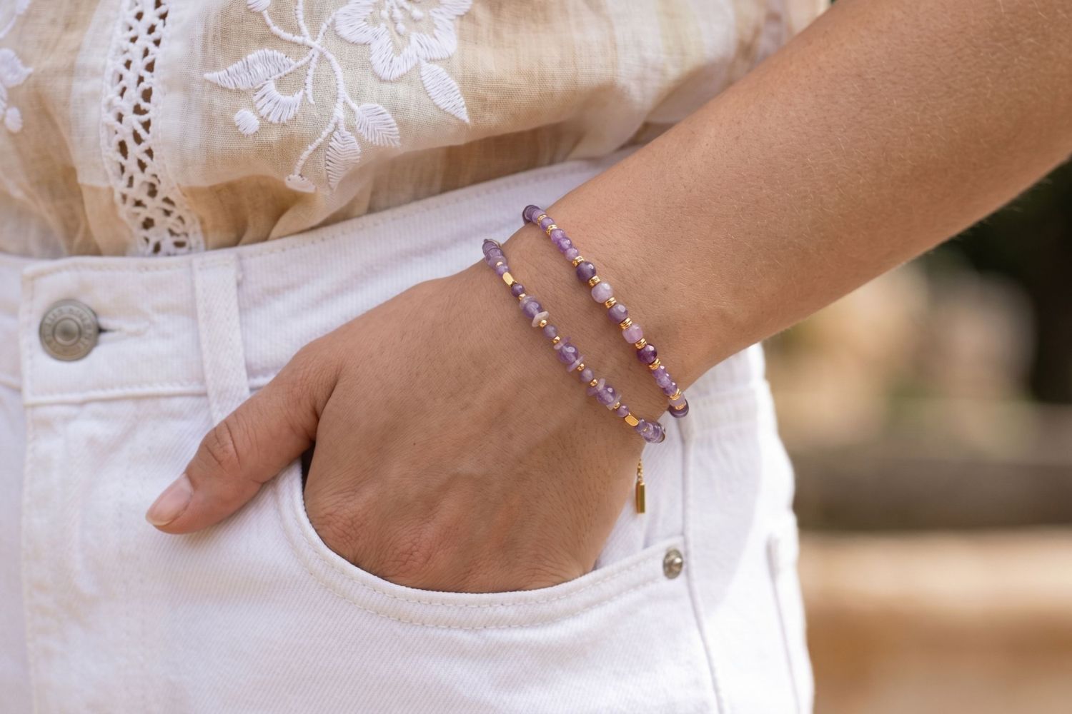 Terceira Amethyst & Gold Bracelet Stack styled on the wrist, showcasing amethyst gemstones, purple jade beads and layered gold bracelet details.