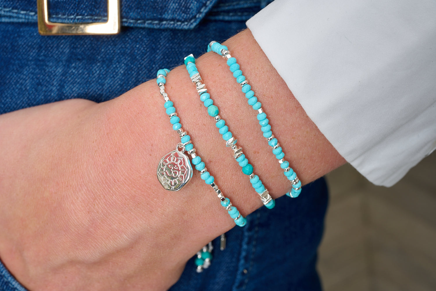 Tortola turquoise howlite silver bracelet stack with Om charm, blue gemstone beads and polished silver accents with adjustable slider fits