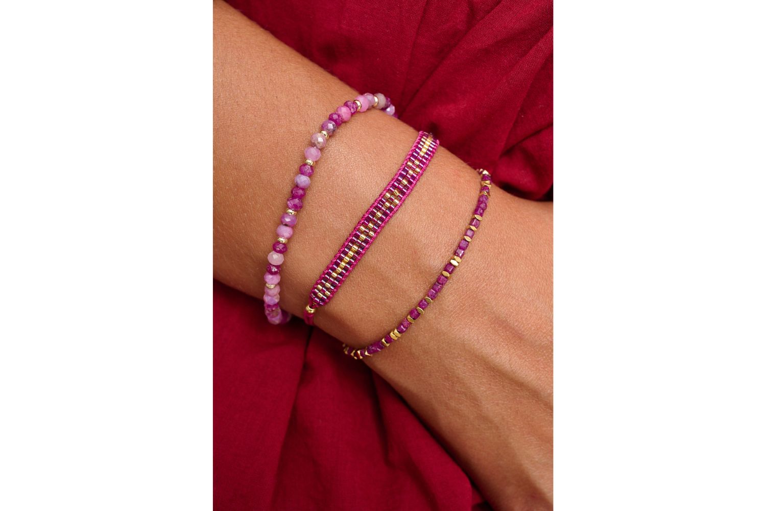 Valentina Gold & Ruby Gemstone Bracelet styled on a wrist, showcasing its vibrant ruby beads, gold details, and passionate boho charm, perfect for layering or wearing solo.