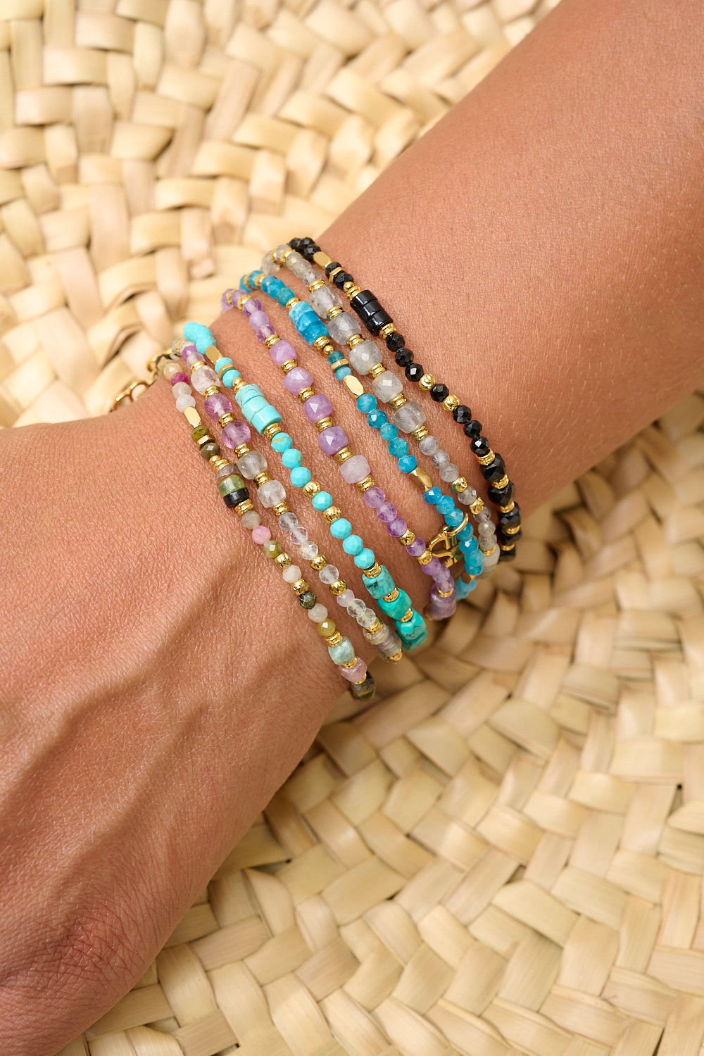 Yasmin Rainbow Fluorite Bracelet styled with layered gold and gemstone bracelets for a colourful, boho-inspired look.