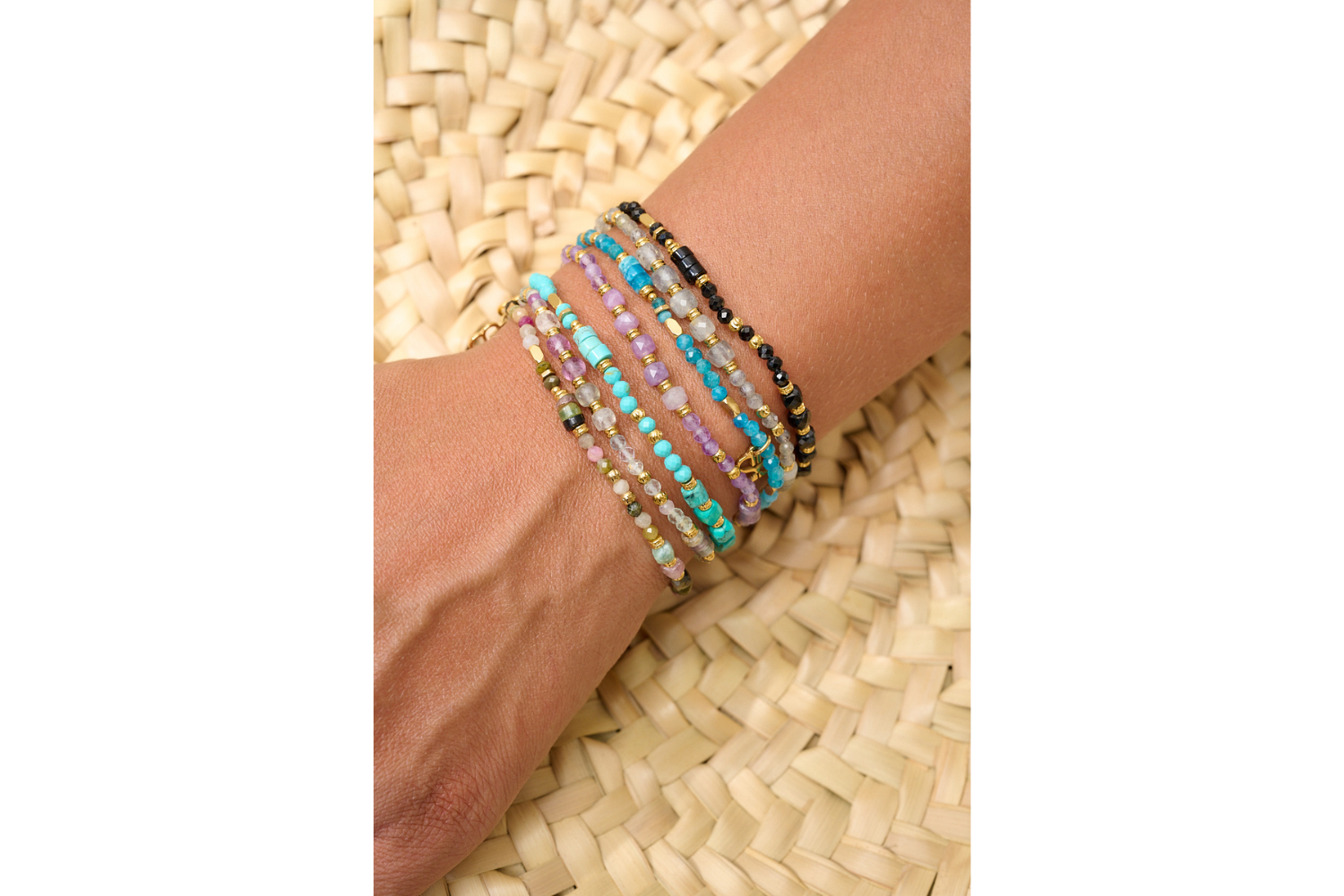 Yasmin Rainbow Fluorite Bracelet styled with layered gold and gemstone bracelets for a colourful, boho-inspired look.