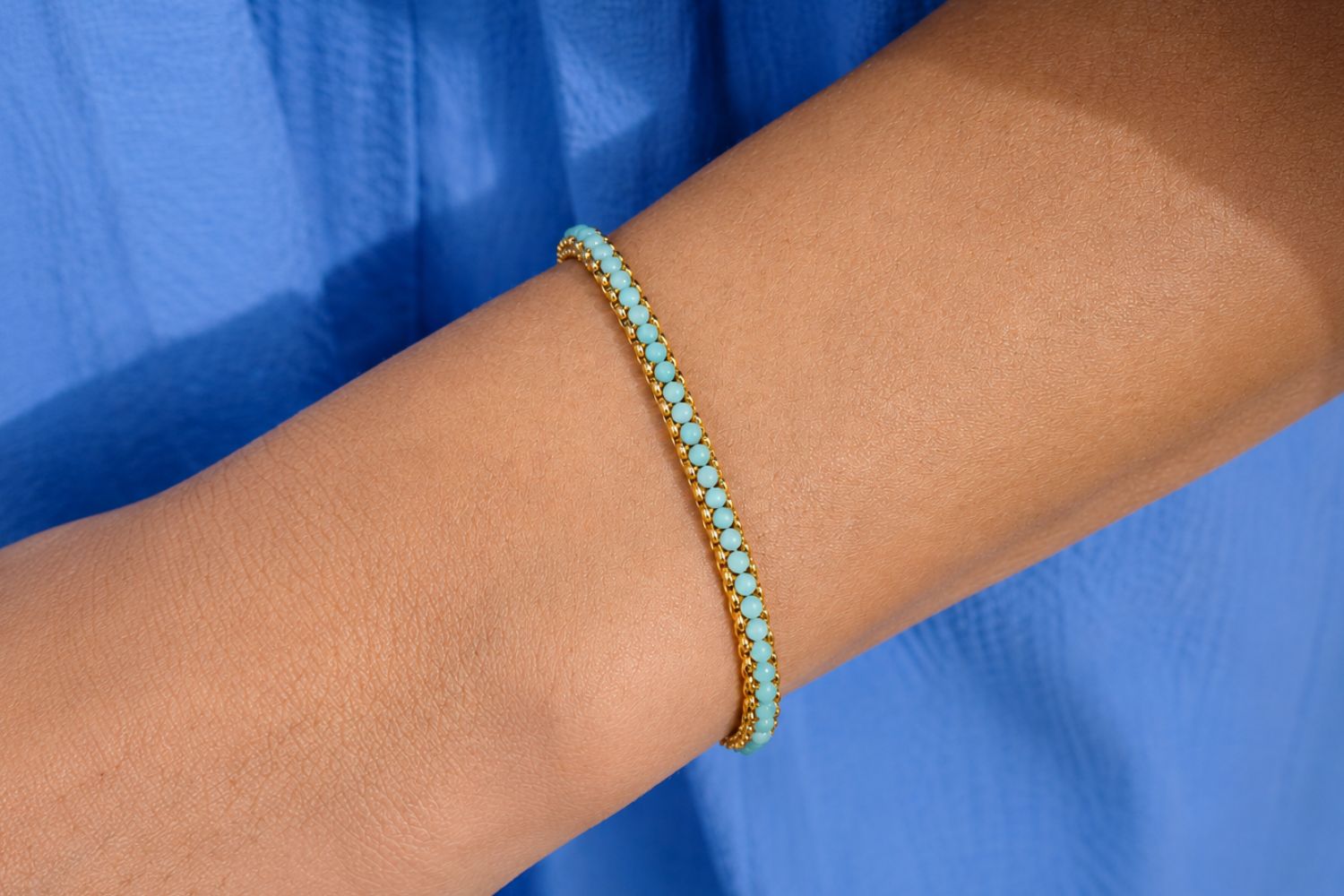 Zena Amazonite Gold Beaded Bracelet styled on the wrist, showing soft sea-green tones and gold accents perfect for layering.