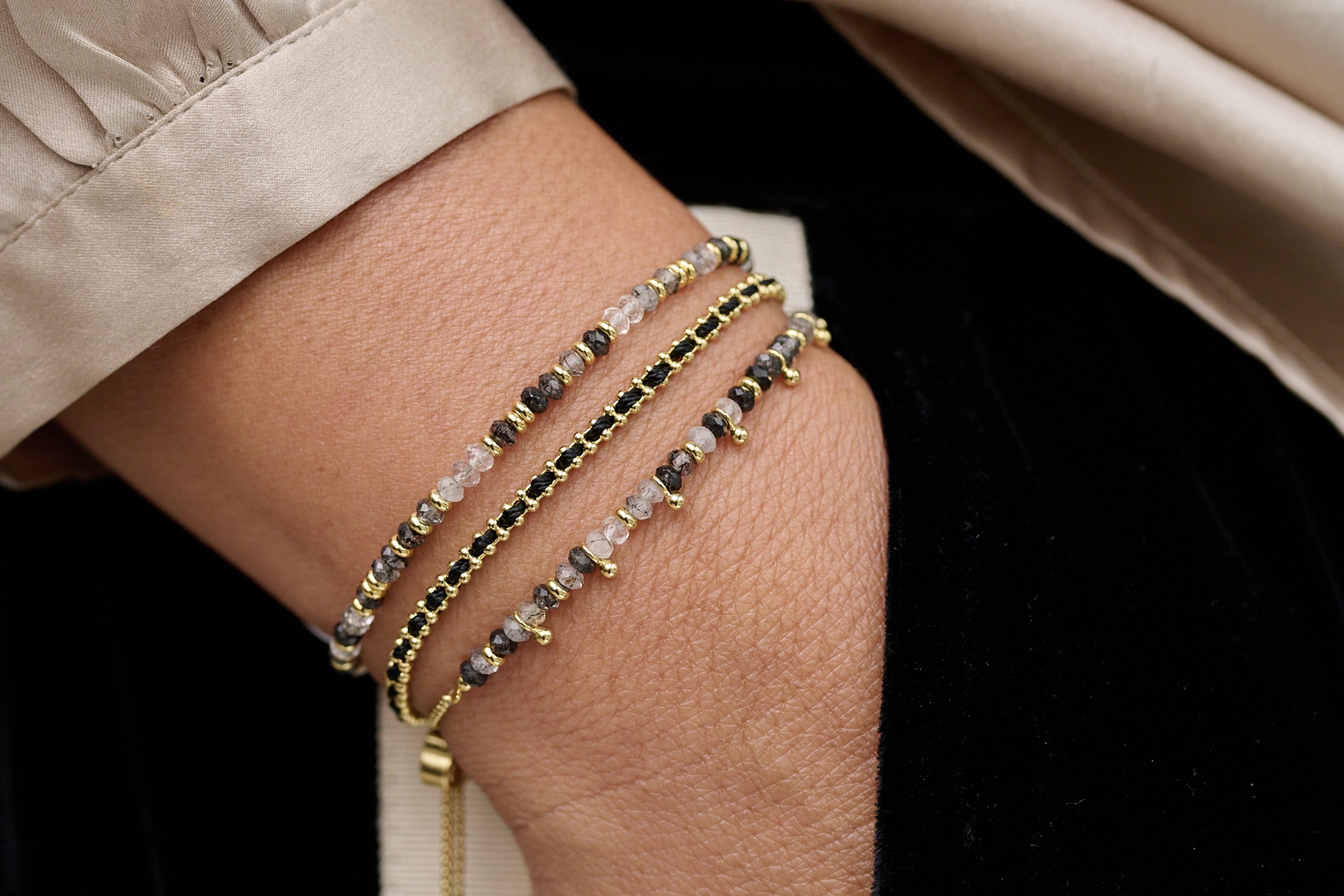 Mystical Black Rutilite Bracelet styled with gold jewellery for an elegant, empowered, and spiritually inspired look.