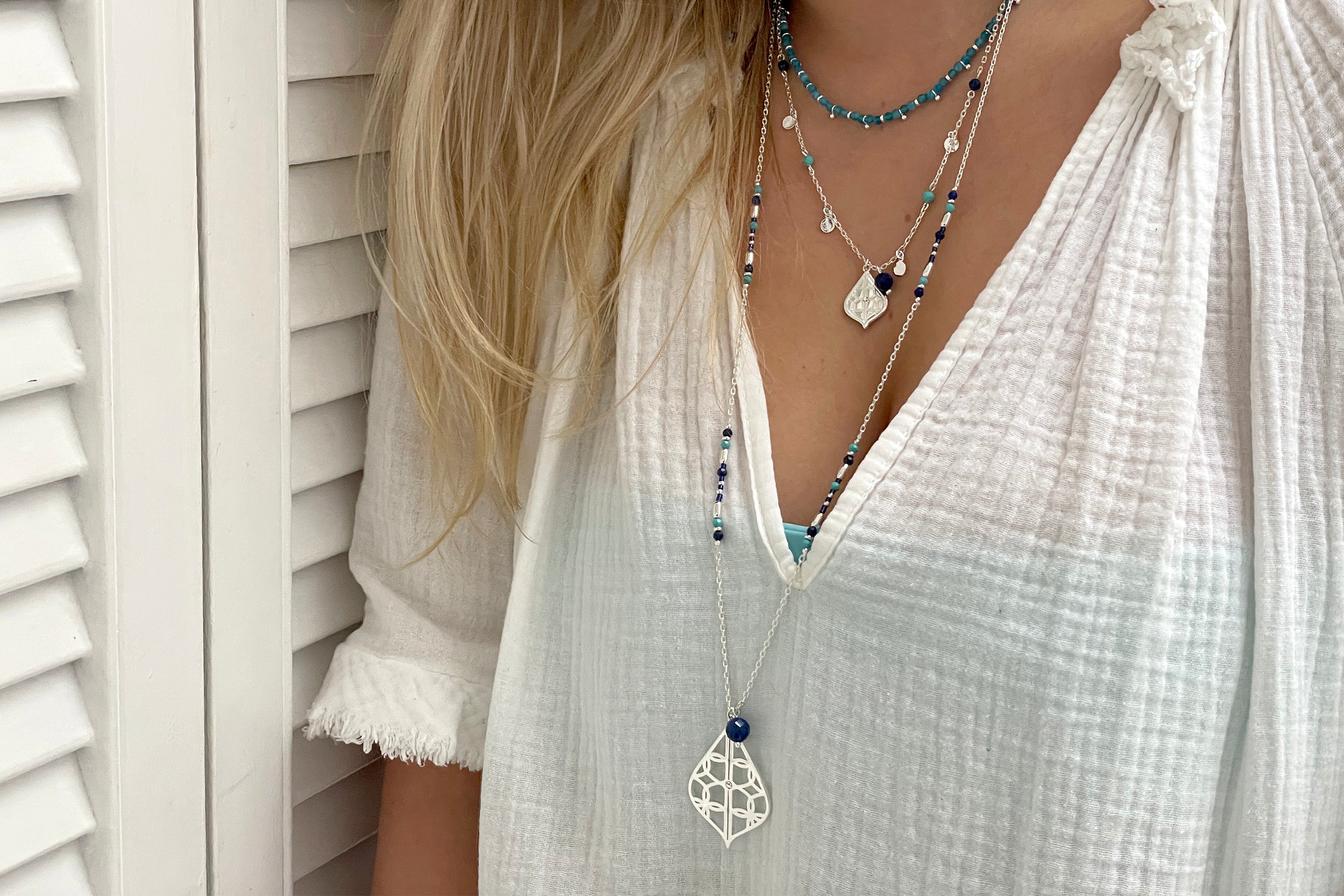 Salus Apatite Silver Necklace styled for a bright, expressive look with calming blue tones and boho layers.